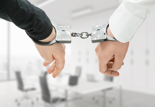 Ransomware concept hands in cuffs