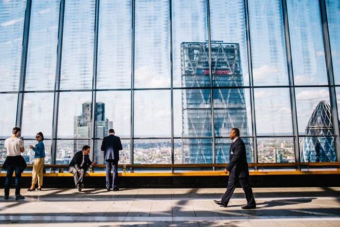 Peeps walking in glass building