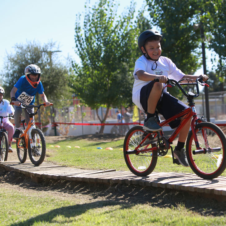 Children ride on the bike track
