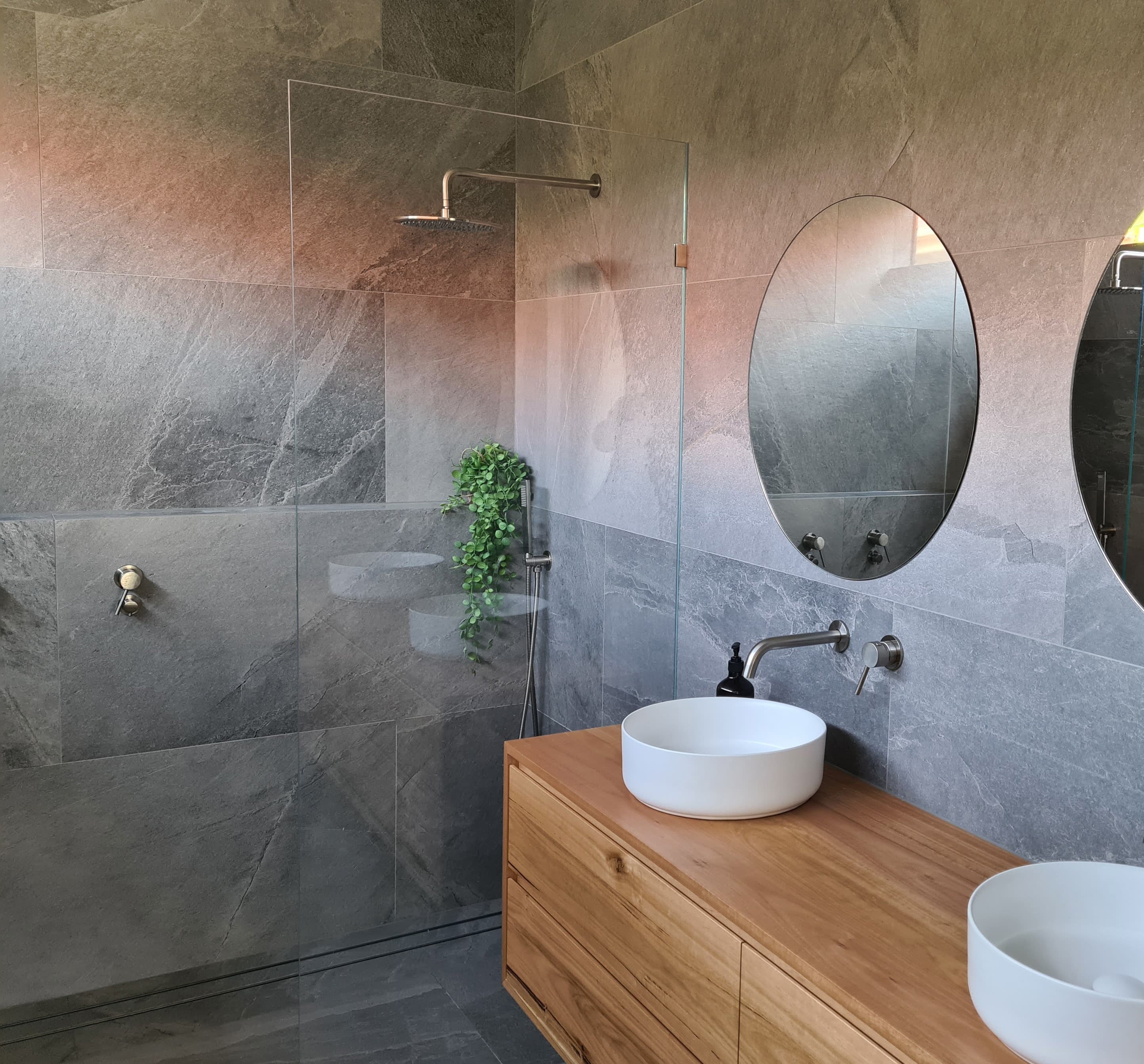 Beautiful bathroom renovation with floor to ceiling tiles and contemporary tapware design.
