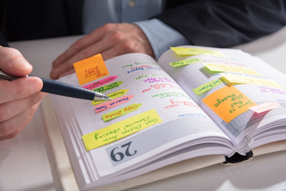 A planner notebook open full of upcoming tasks.