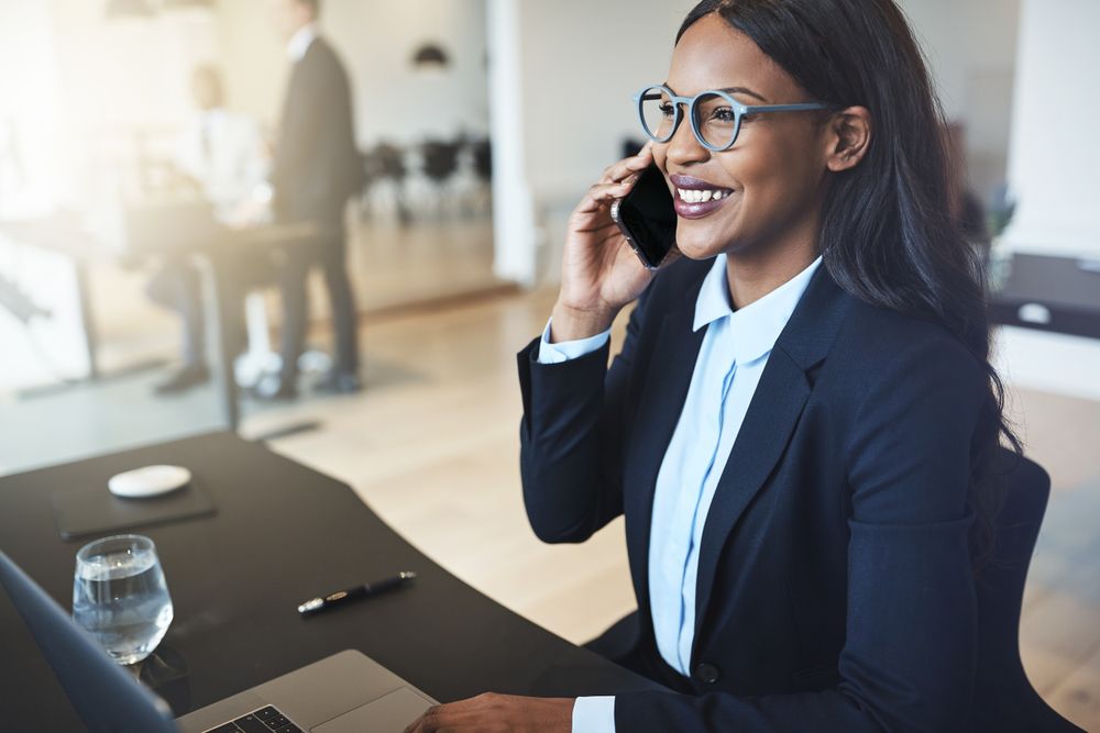 A business woman with glasses on the phone.