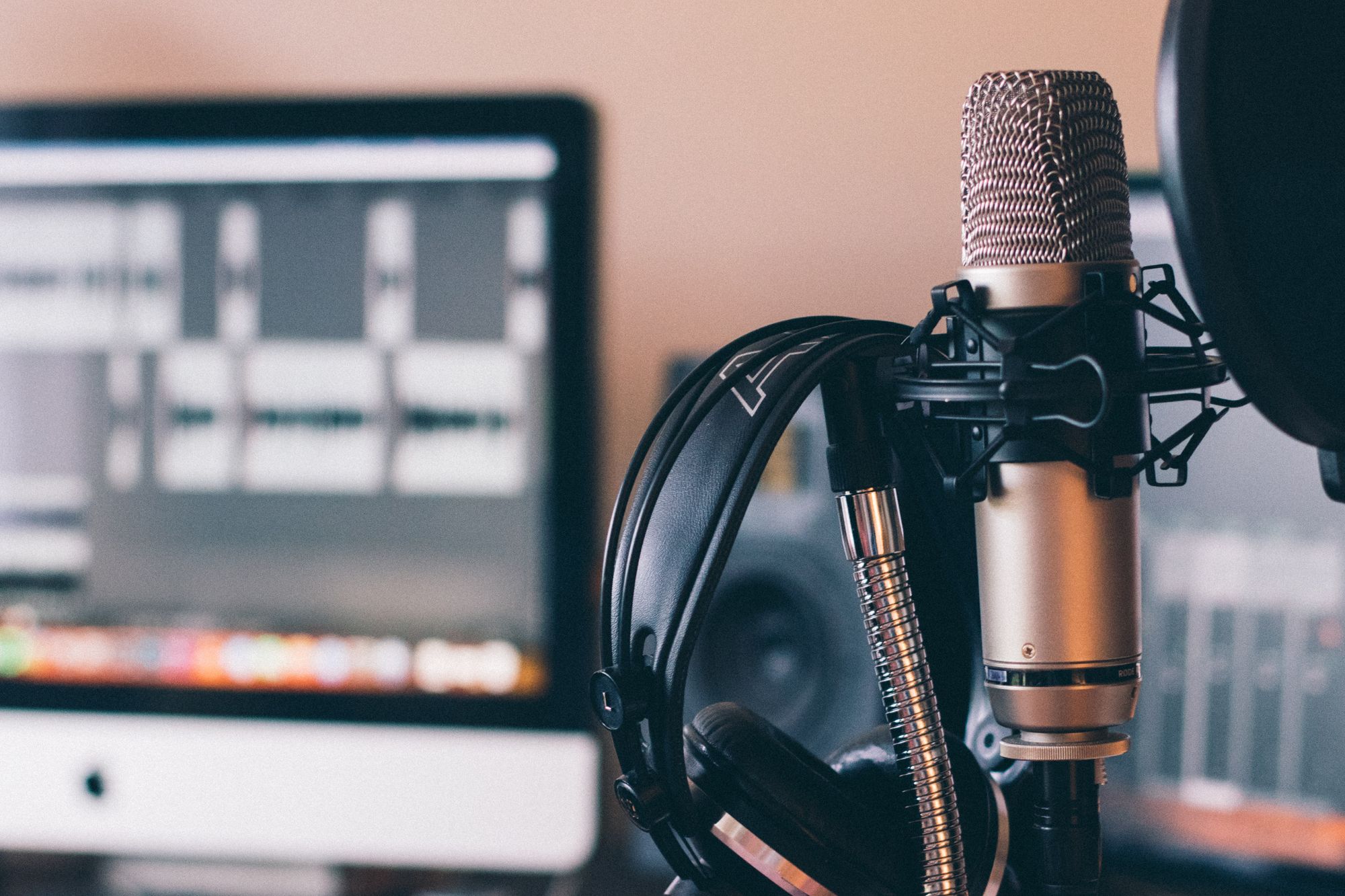 A microphone and headphones set up by a computer.