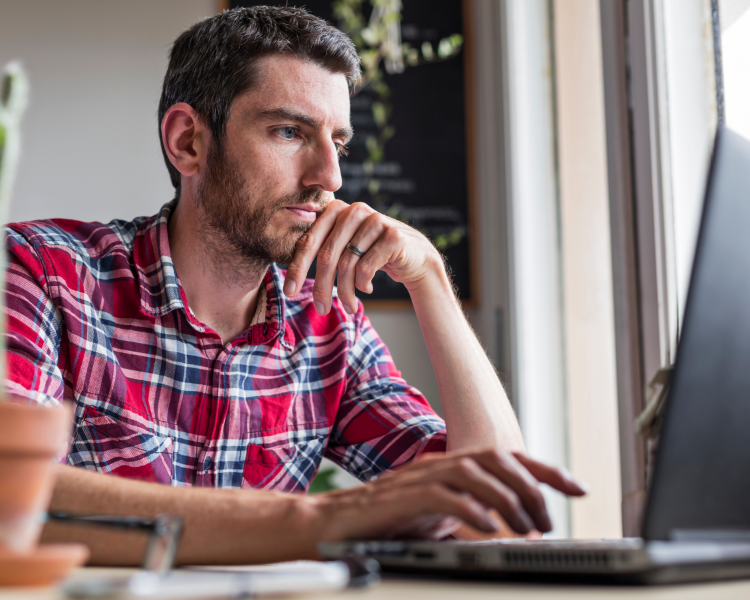 man buys us email list while looking at laptop