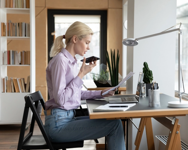 woman referring to her sales scripts while on a call