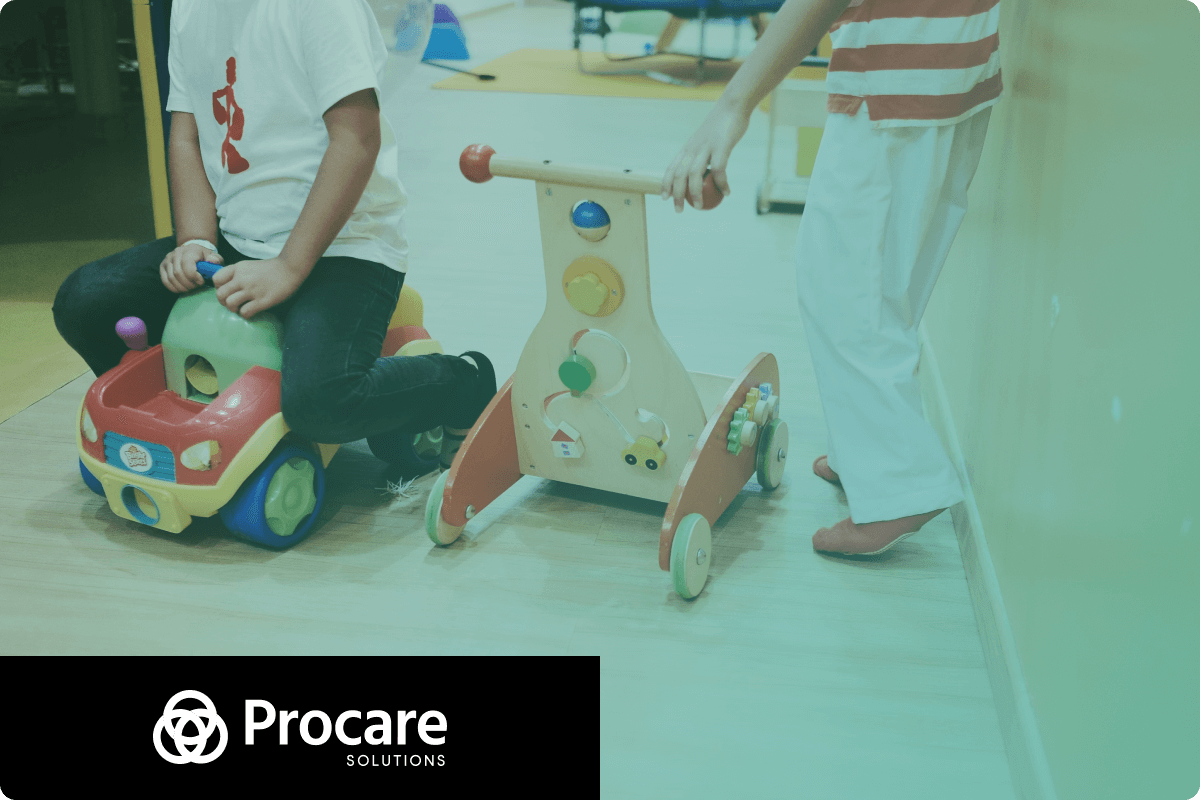 Two children are playing - one of them drives a car toy, and second child drives another wooden toy