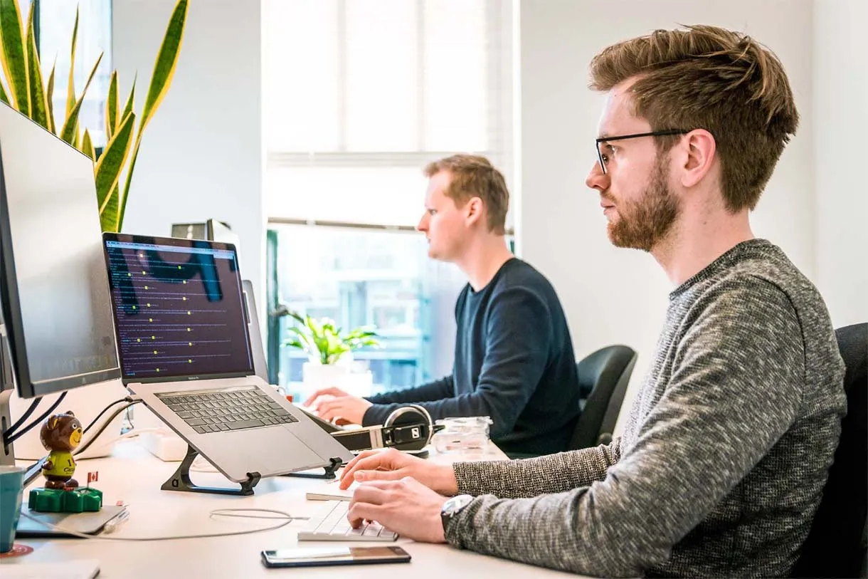 two developers sitting at a desk working