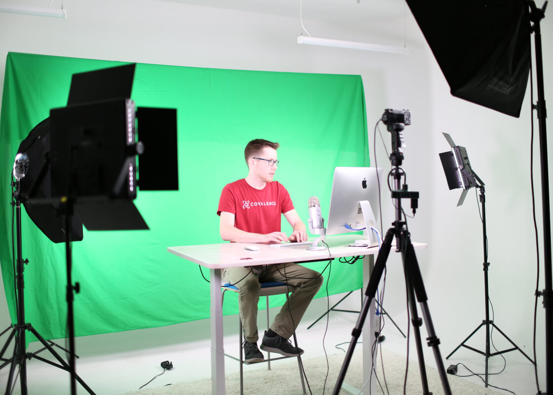 guy at computer in chroma key recording studio