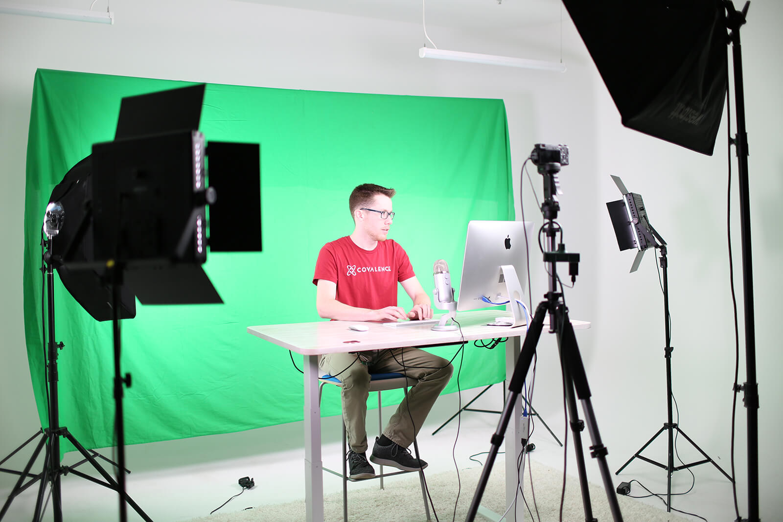 guy at computer in chroma key recording studio