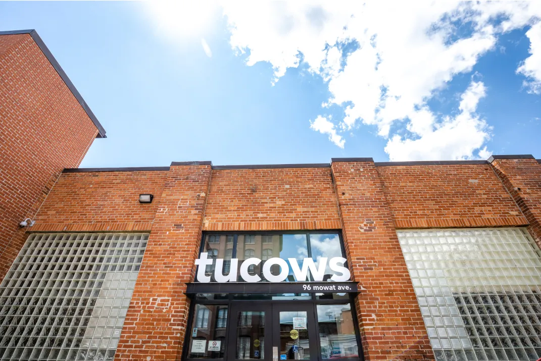 The entrance to the Tucows Toronto headquarters, an old brick facade with large glass block windows