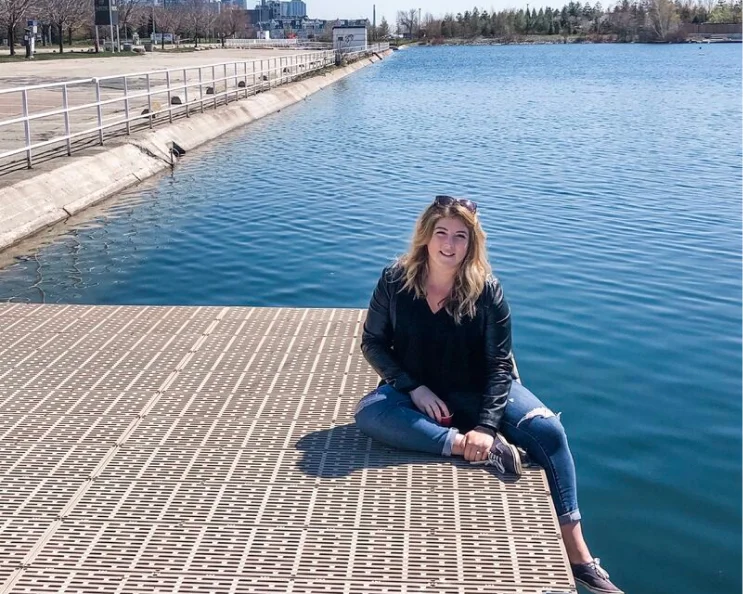 Madeleine stopping to sit by the water at the Toronto harbour