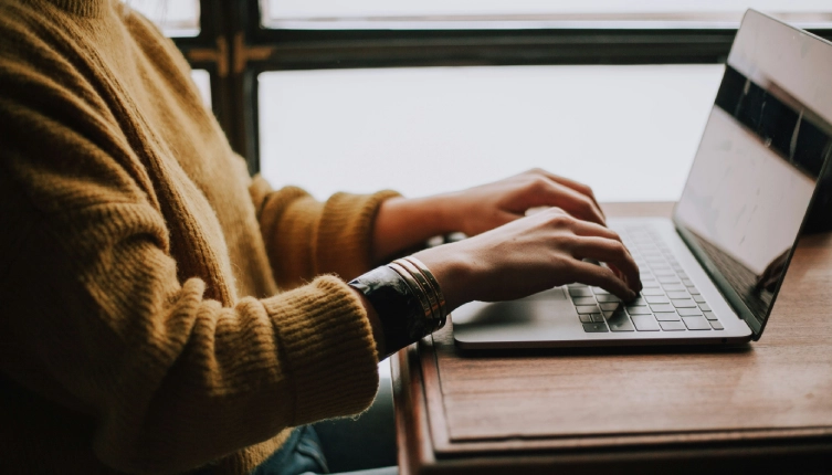 A person conducting mandatory training on a laptop