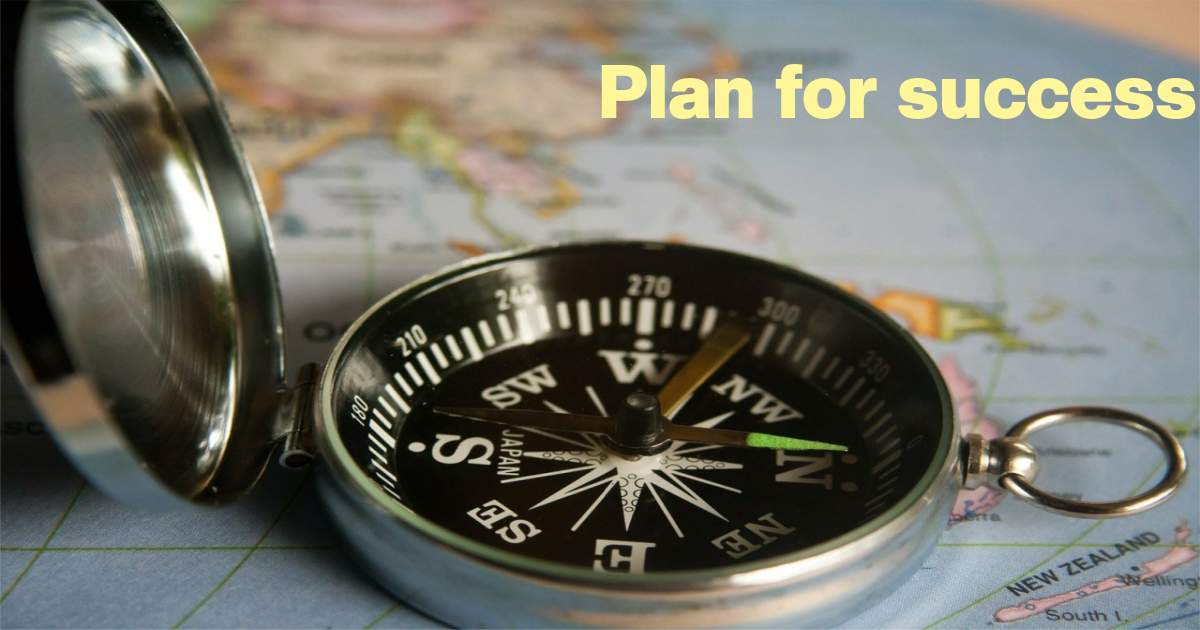 Compass lying on a map; caption reads plan for success