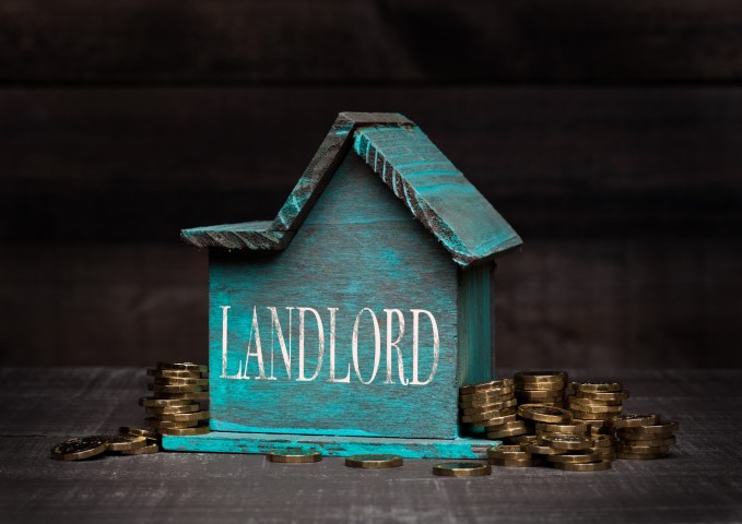 Wooden house with landlord text and coins