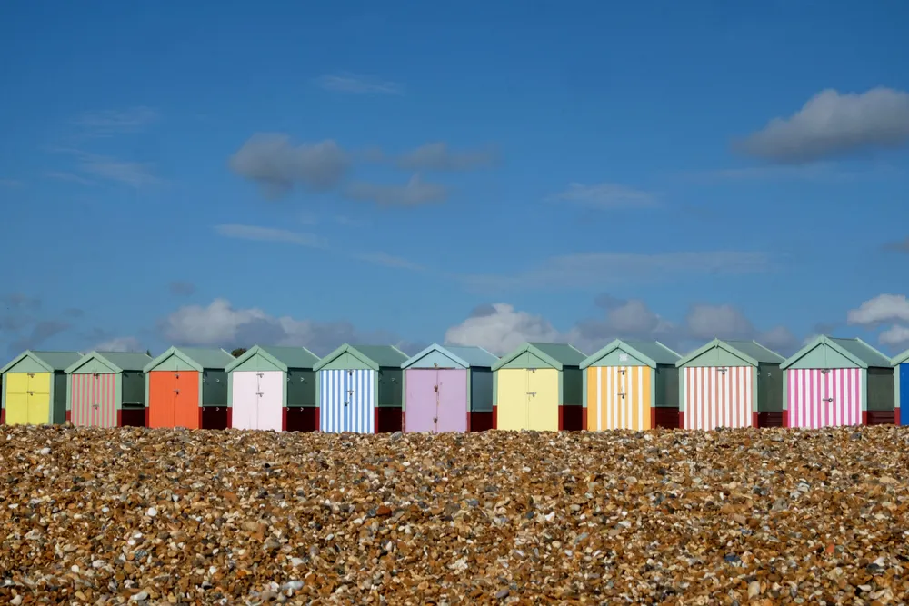 Row of beach huts on a stony beach 