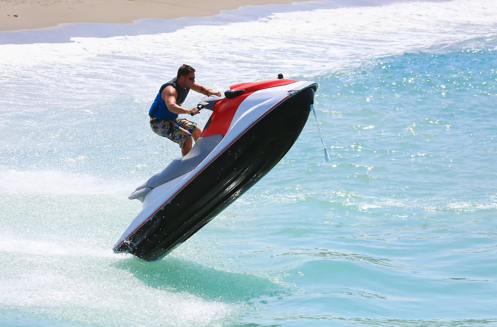 Man on jet ski doing a lift trick