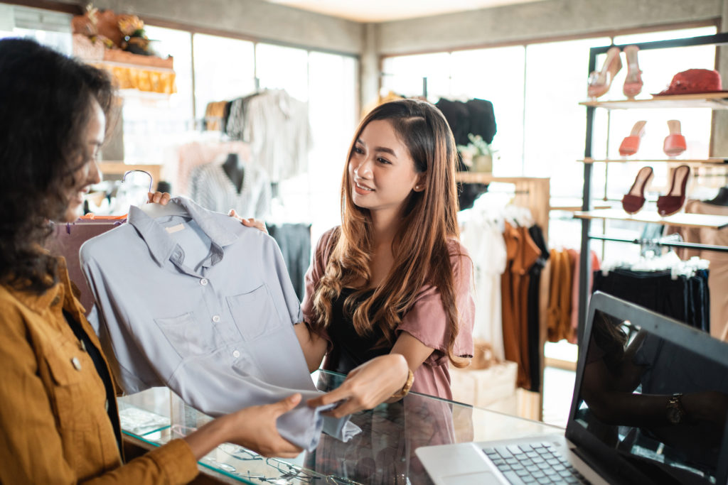 A shopper returning a shirt to a retailer due to it being the wrong size