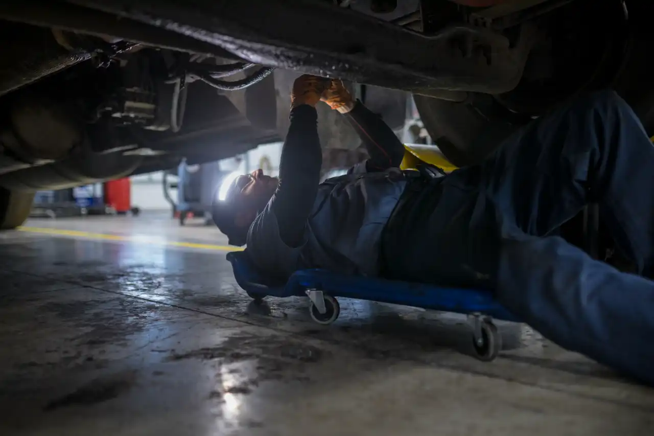 Mechanic providing heavy equipment maintenance in repair shop