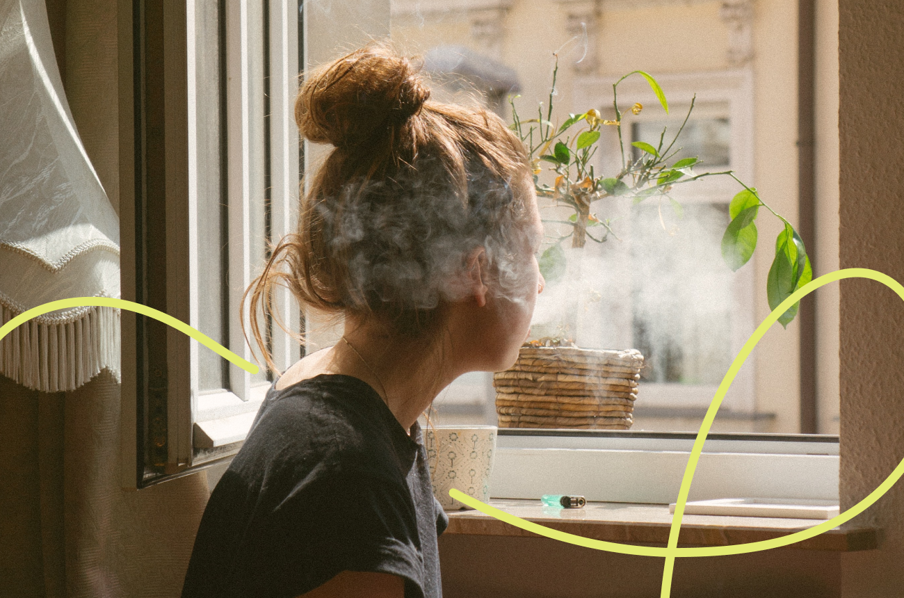 Woman with smoke coming out of her mouth