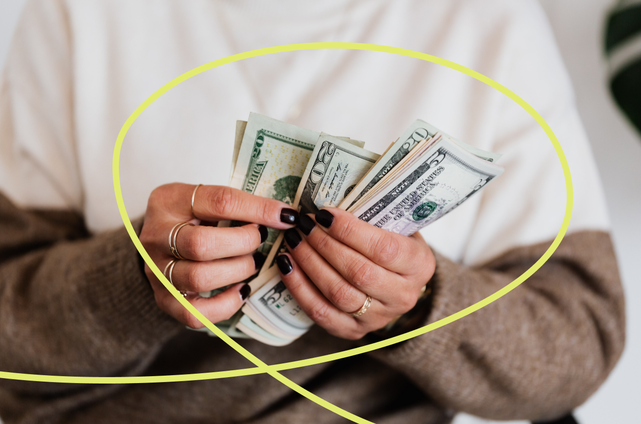 Man holding cash with yellow swirly line