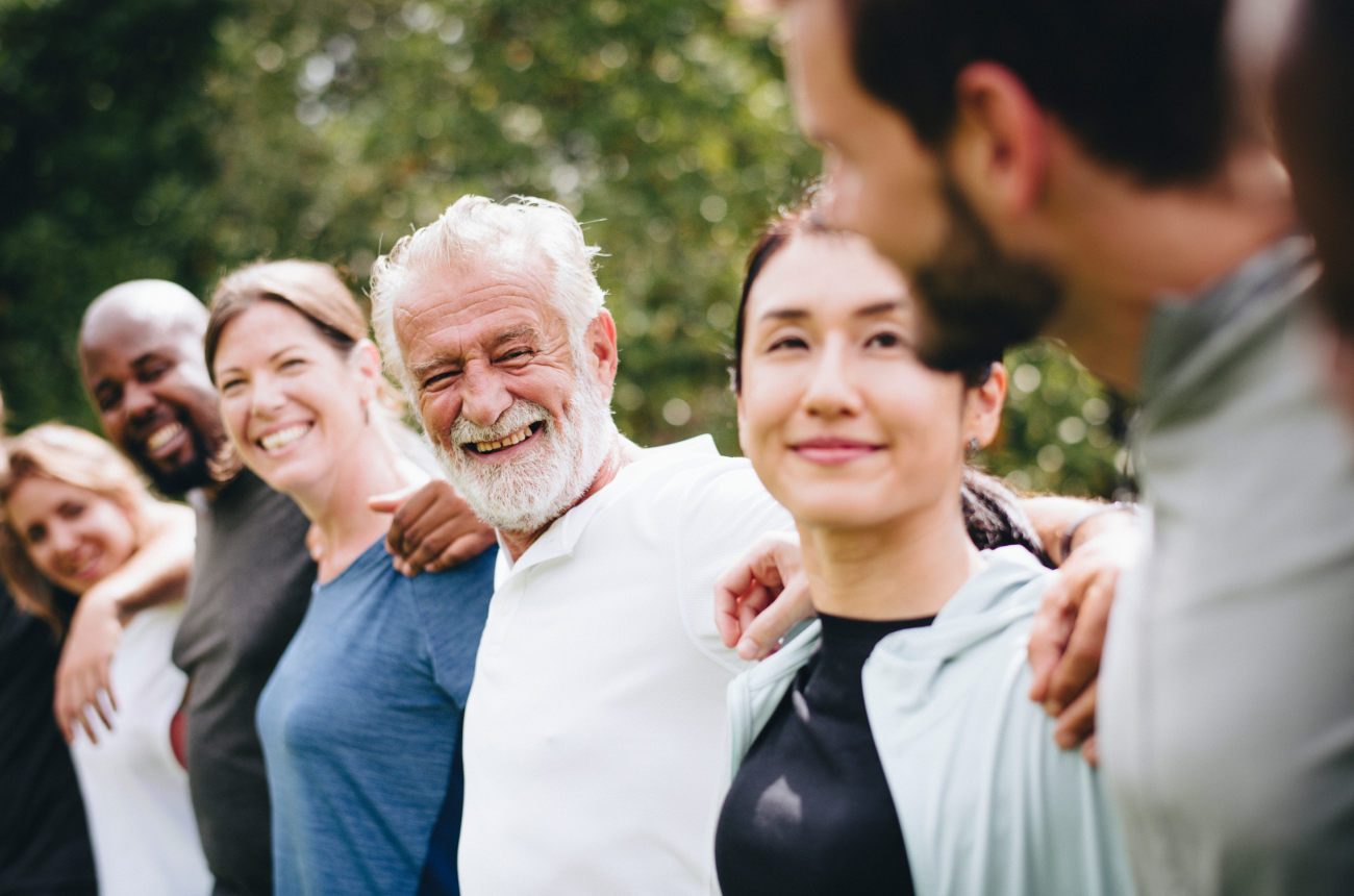 Group of people with arms around each other