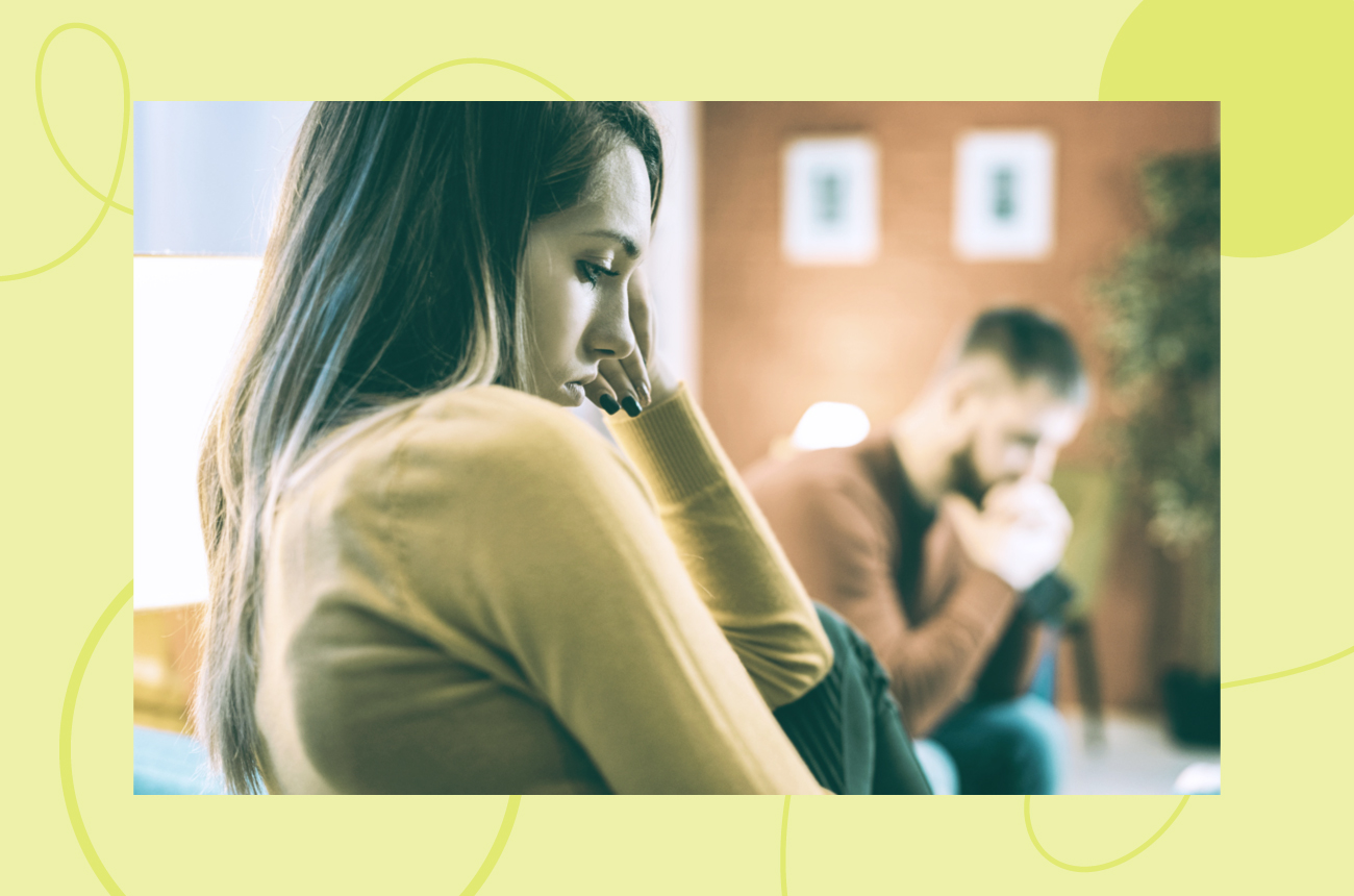 Man and woman sitting in a waiting room together looking sullen and frustrated