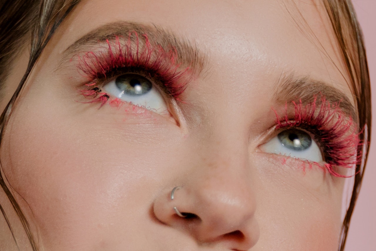 Close up of woman wearing red fake eyelashes