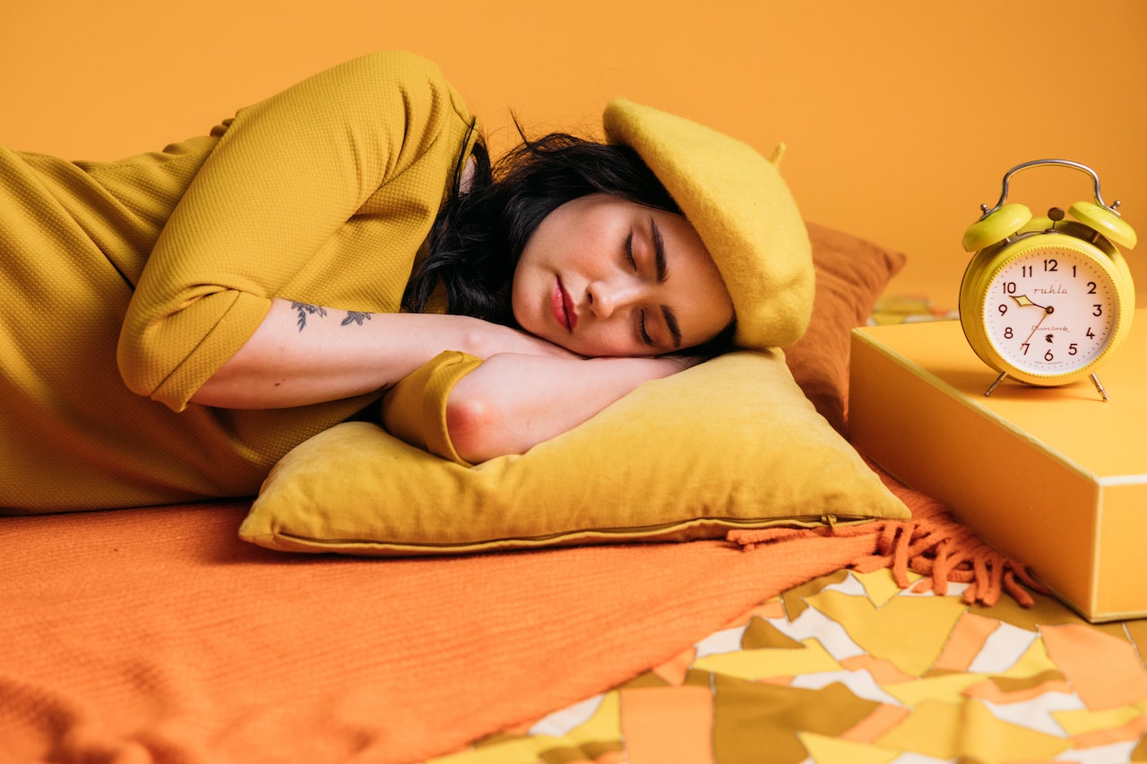 A Sleeping Woman In Yellow Outfit and Background