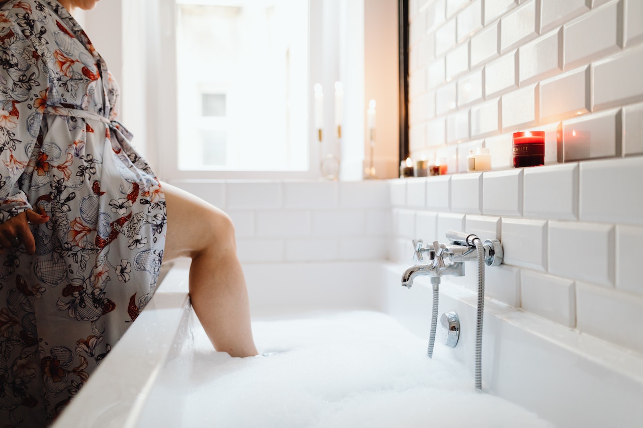 A Person Wearing a Bathrobe in the Bathtub