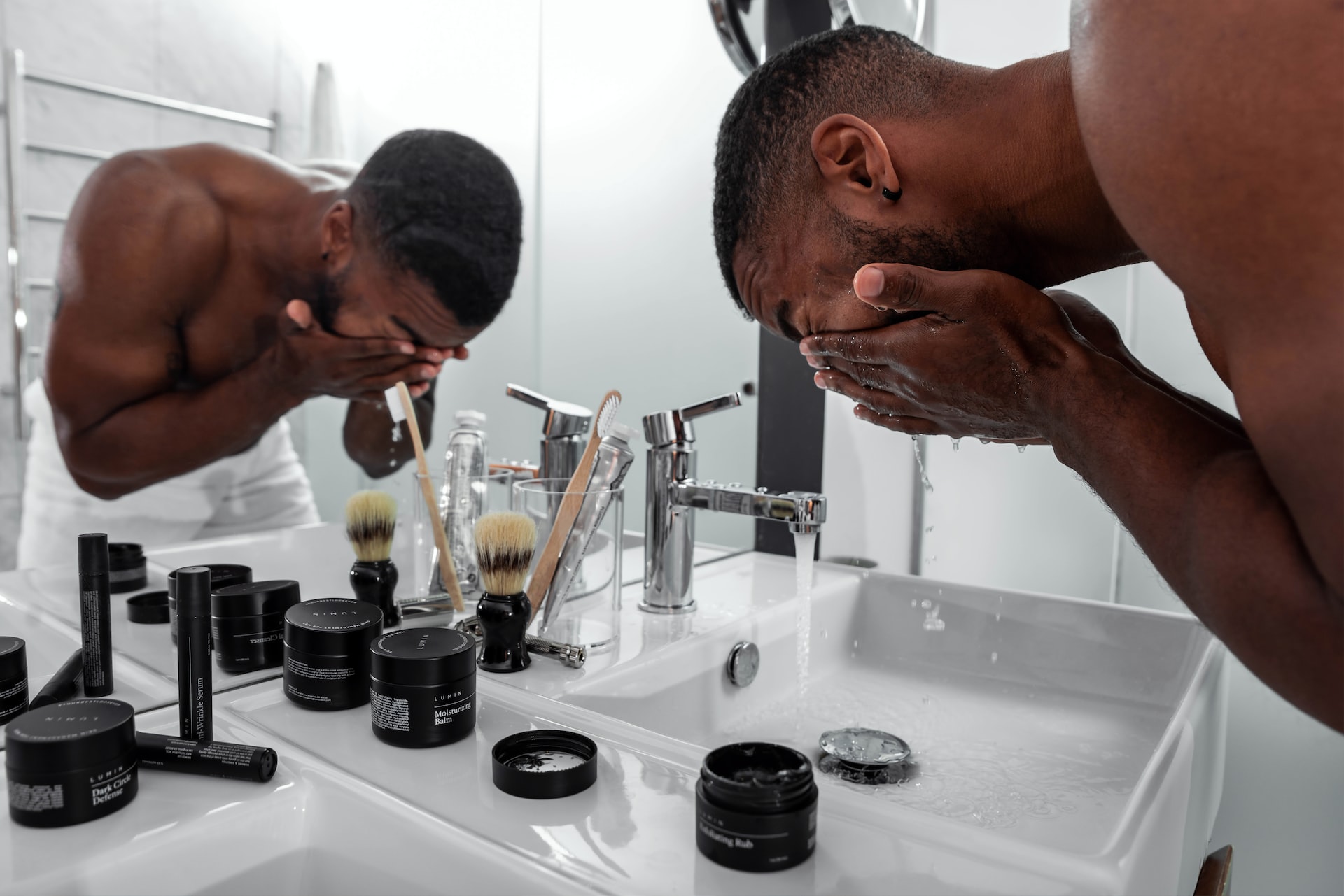 man-washing-his-face-in-the-bathroom