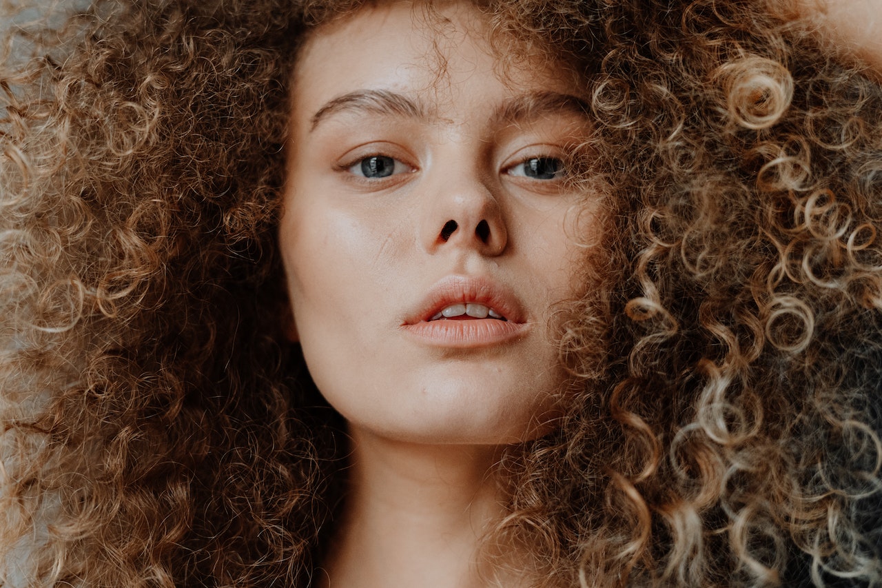 beautiful curly haired woman with no makeup on her