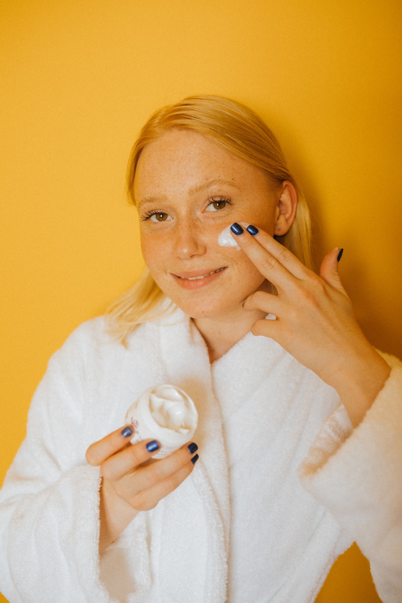 Woman-Applying-White-Cream-on-Her-Face