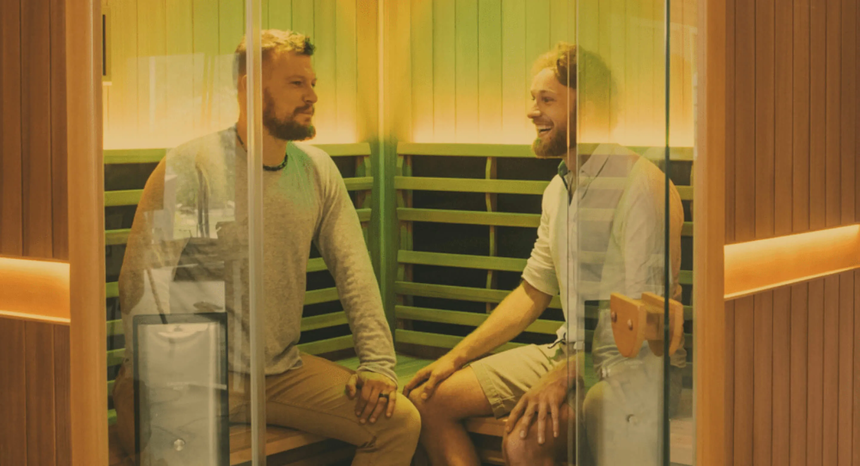 Clearlight co=founders Sebastian Miereu and Johannes Kettelhodt, sitting inside a Clearlight Sanctuary Corner Infrared Sauna.