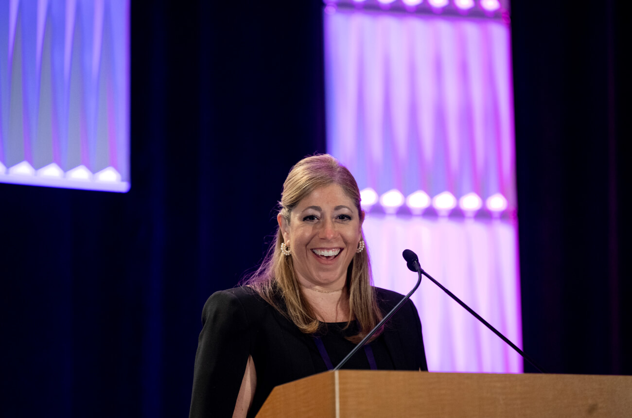 EMA member Lisa Pelrine at the annual conference main stage podium.