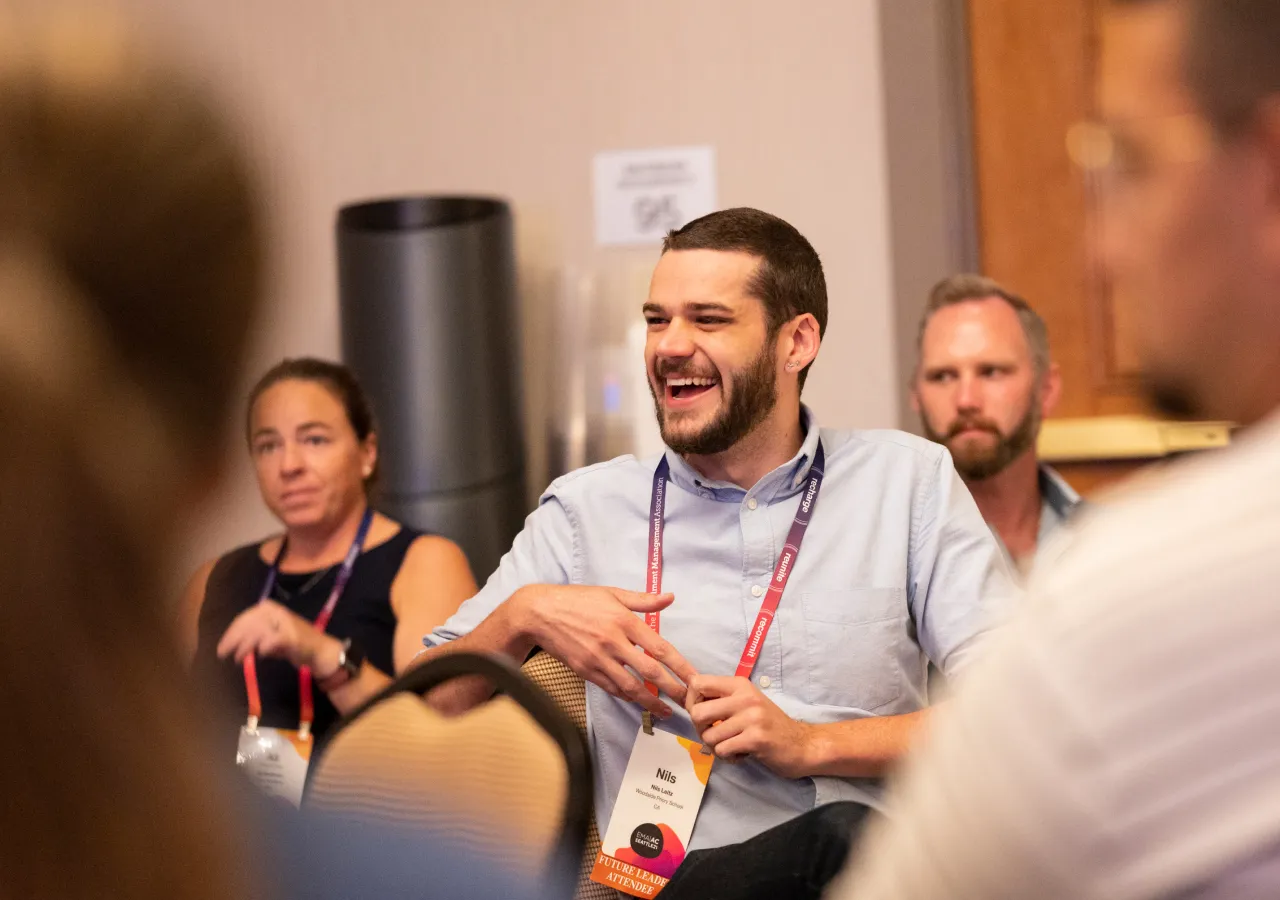 EMA members conversing and laughing during a seminar.