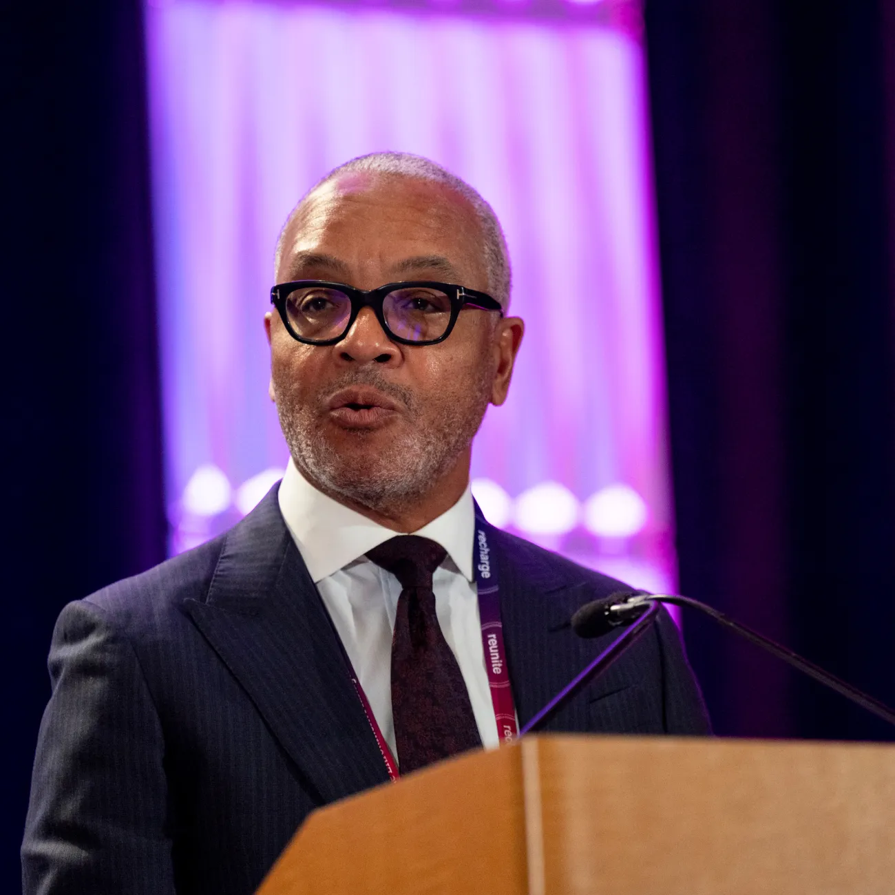 Dallas Joseph, EMA Board Chair and Vice President of Finance and Operations at Baylor School speaking at the annual conference main stage podium.