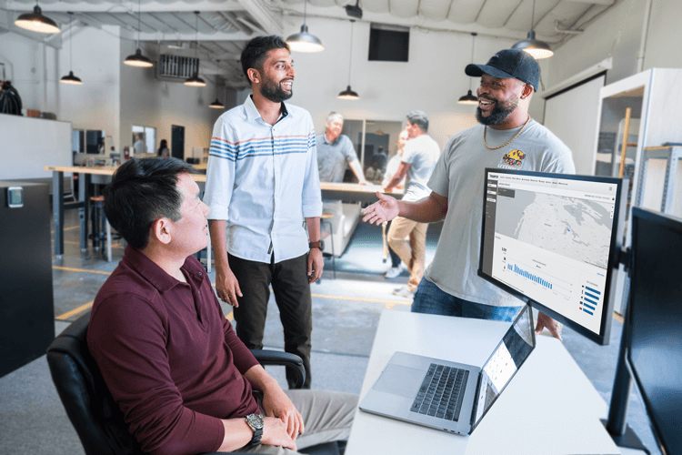 3 people at a computer