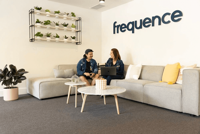 2 people talking on a couch