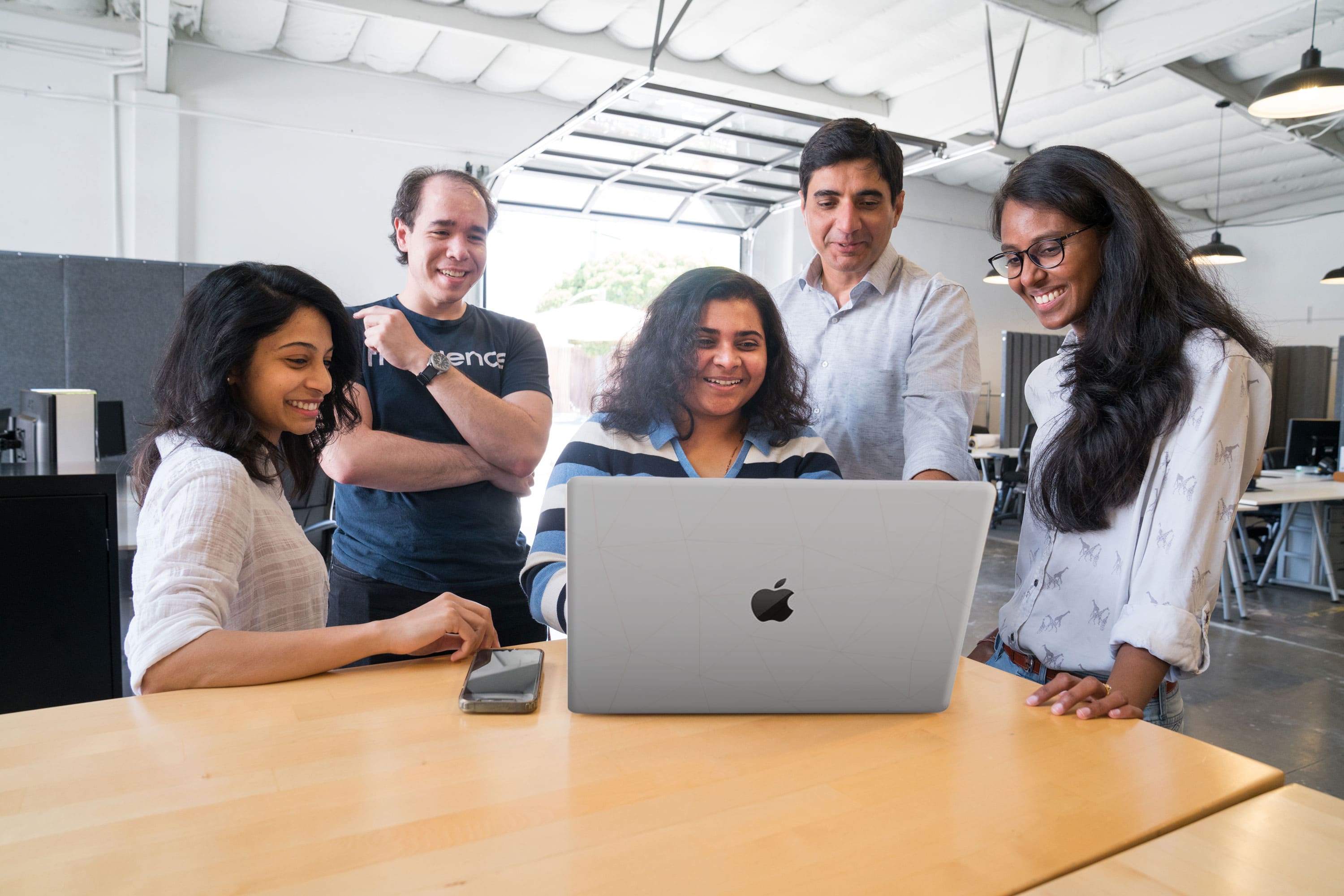 5 people at a computer