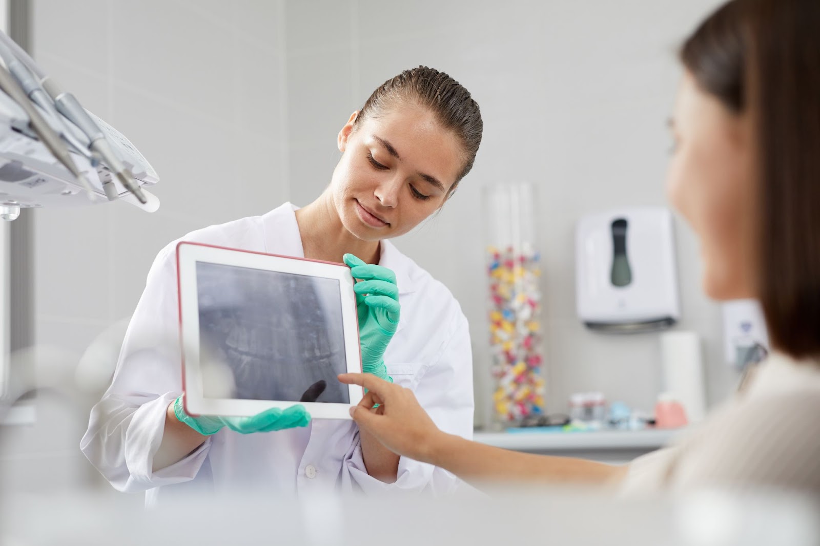 treatment coordinator reviews intraoral photos with a patient