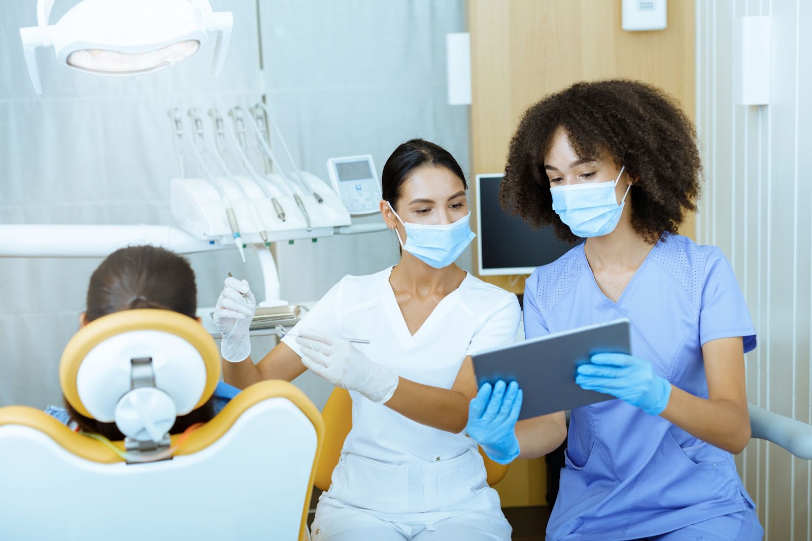 doctors present treatment plans to patient on an iPad in the operatory