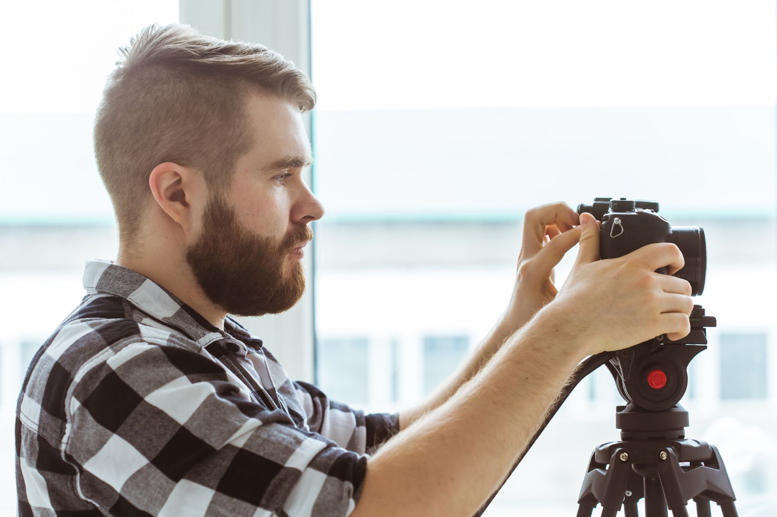 man setting up video recording equipment