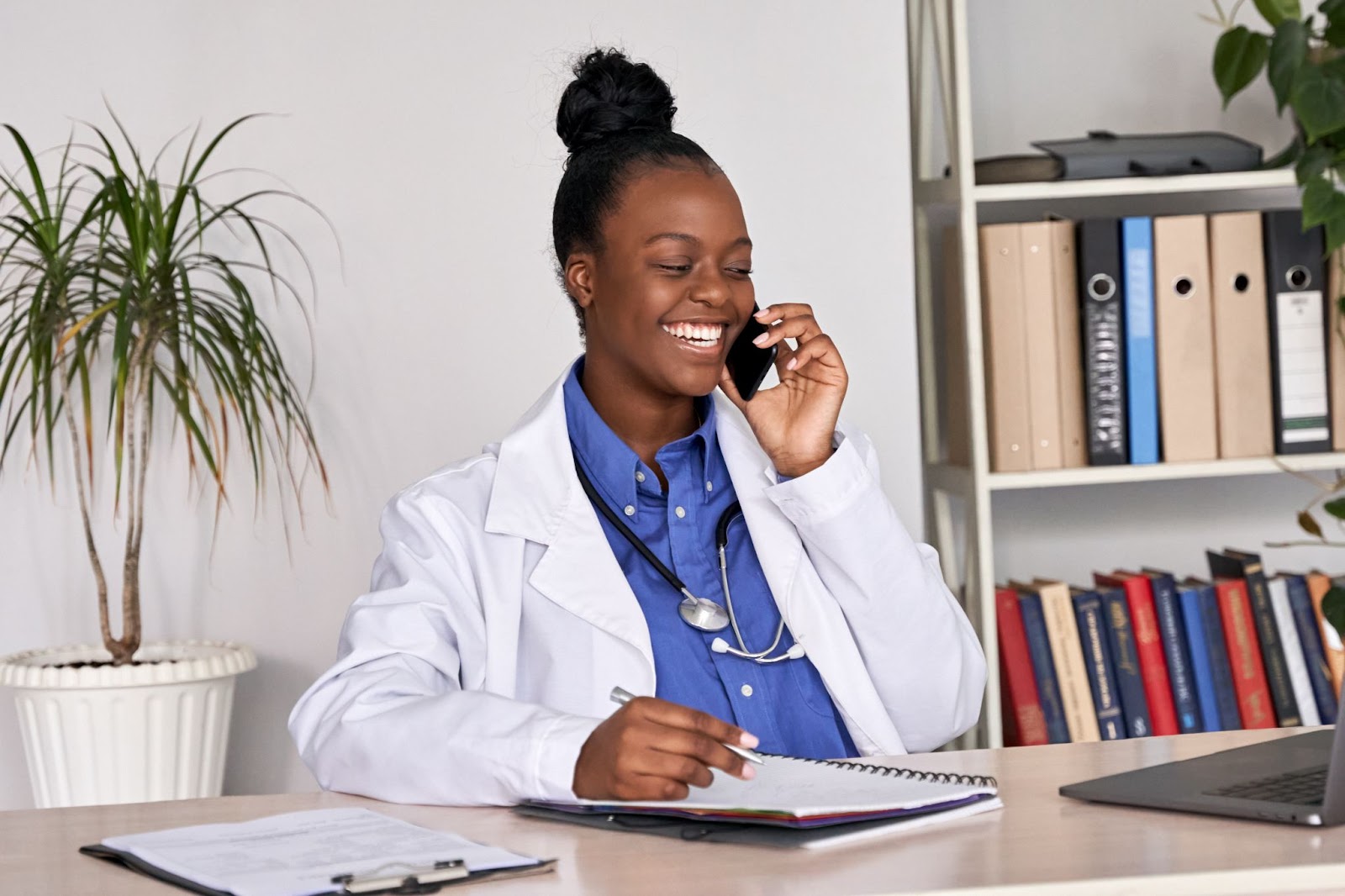 a doctor take a phone call from a patient