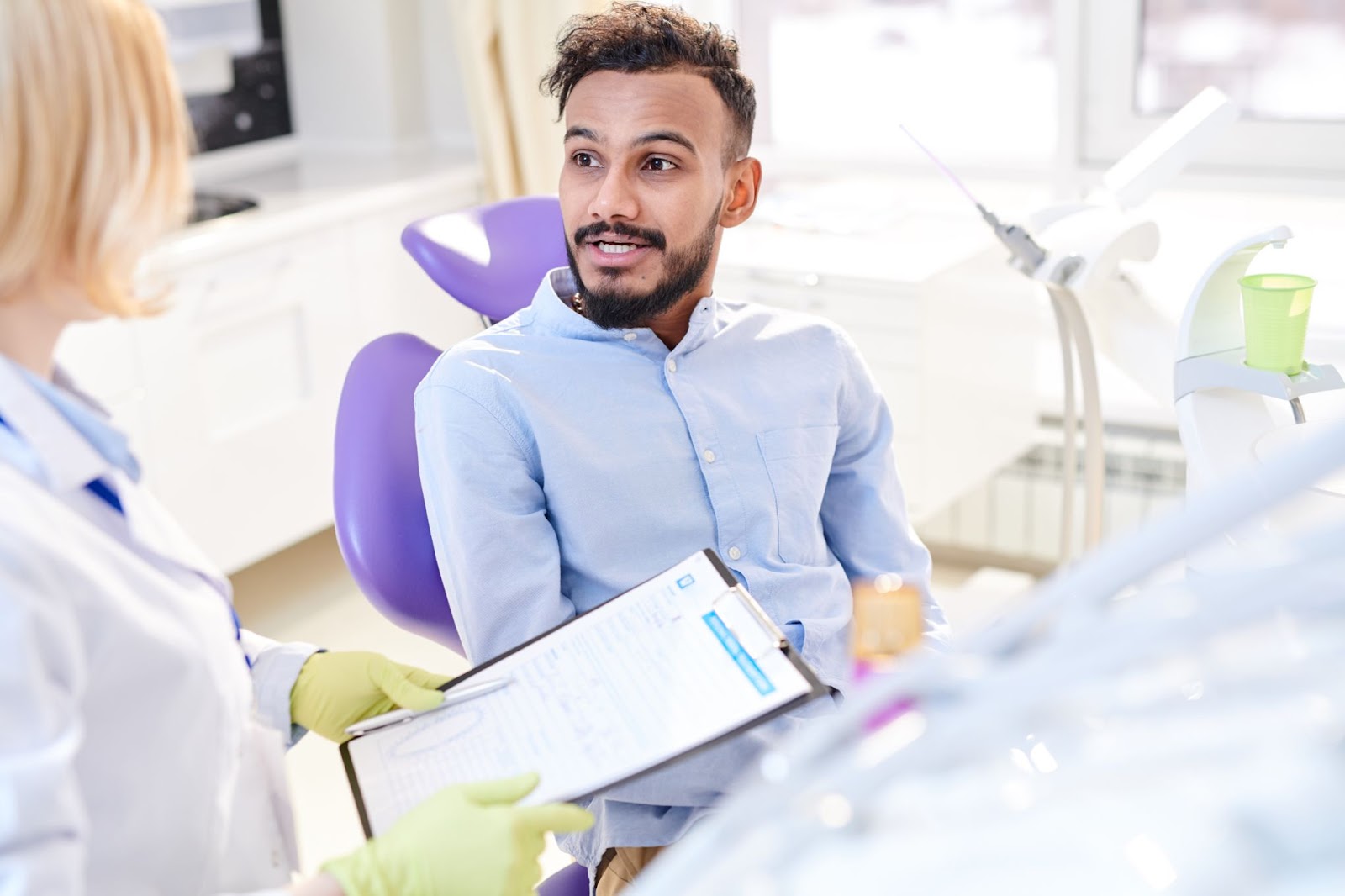 treatment coordinator speaks with a dental patient