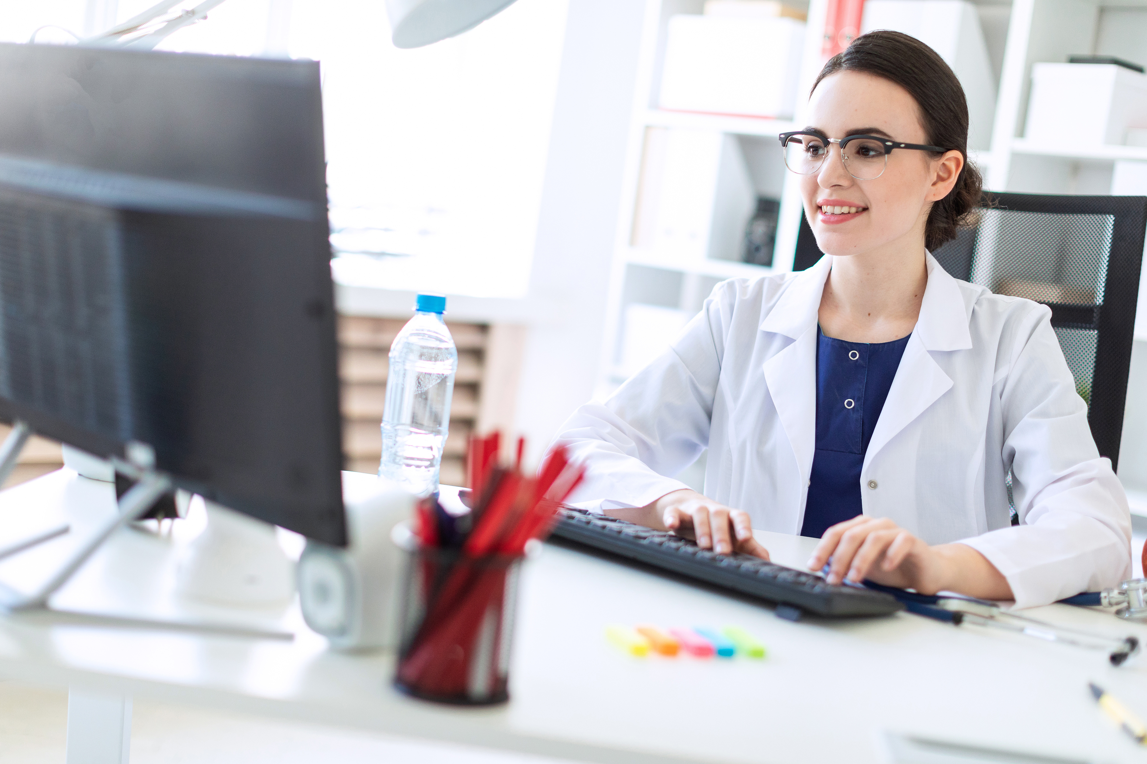 office manager live chats with patients on the computer