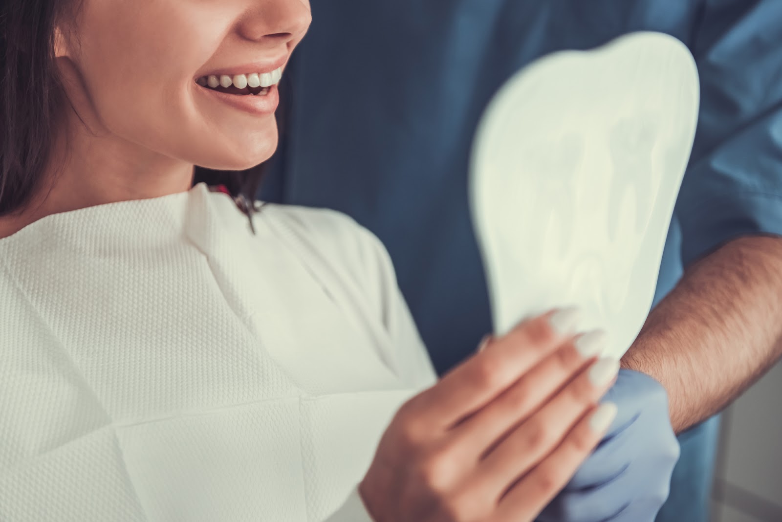 patient admires their smile after dental treatment