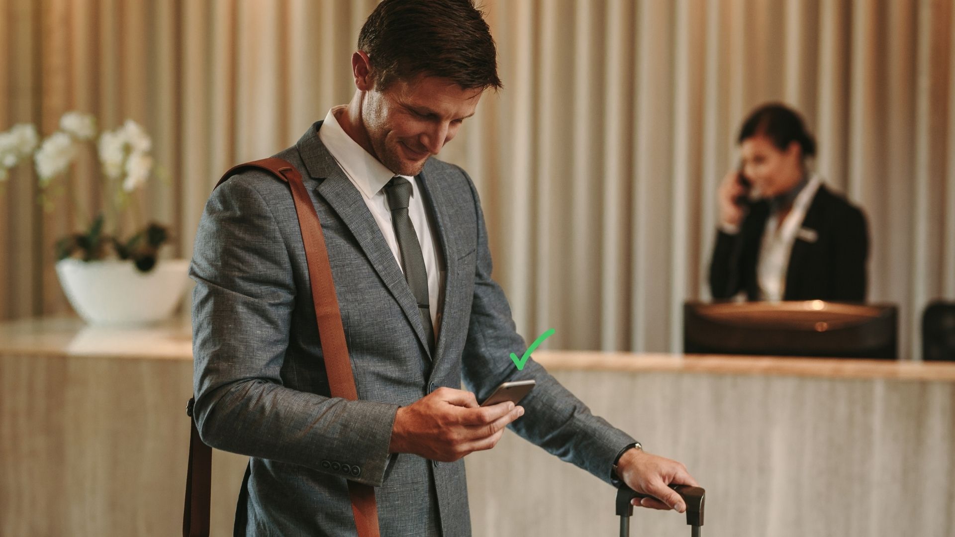 hotel guest checking emails on smartphone