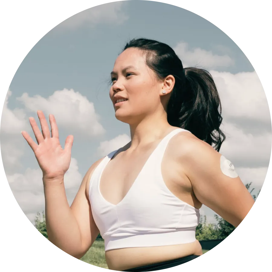 A woman running wearing a Nutrisense cgm sensor on her left upper hand.