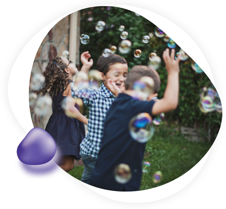 Children playing with bubbles outside