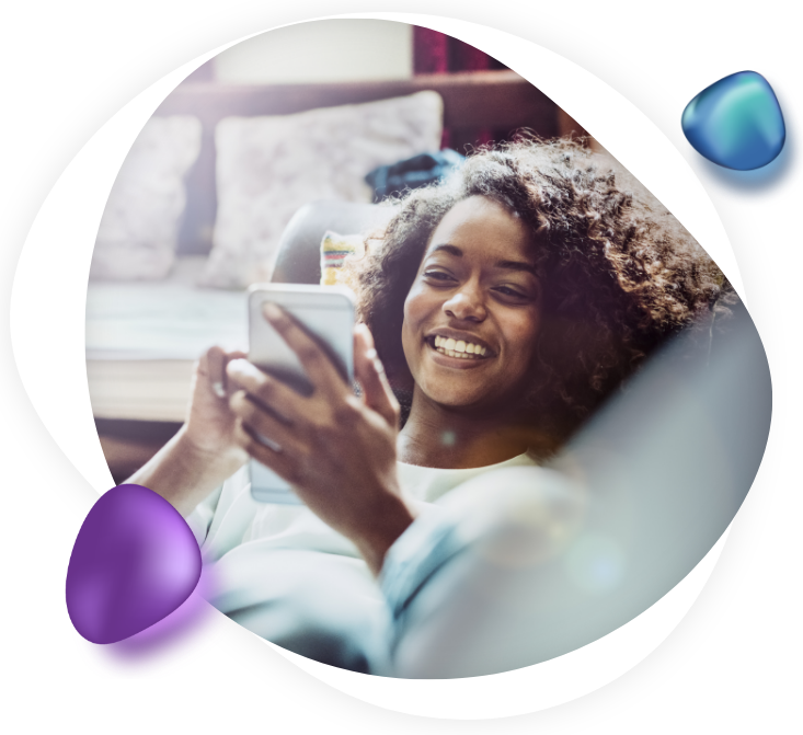 Young woman smiles as she scrolls her mobile device